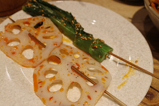Lotus root and vegetable on bamboo skewers from Leshan Bobo chicken (Cold Skewered Chicken) in a restaurant, Leshan, Sichuan Province of China