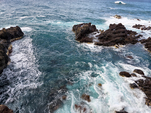 Ocean Waves Breaking Around Rocky Shoreline