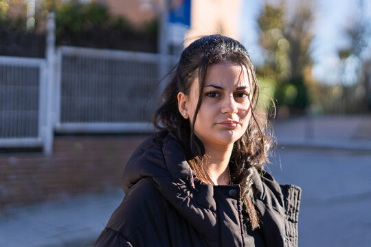 Young woman looking at camera in urban setting