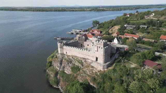 Drone shot flying backward revealing medieval Ram fortress located on the bank pf Danube river in eastern Serbia.