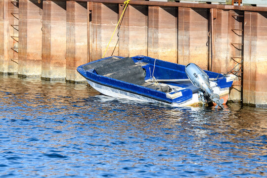 Small Boat At A Large Wharf