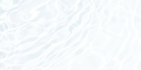 Obraz premium Clear water surface with soft ripples and bright light reflections creating a gentle abstract pattern texture
