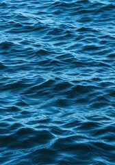 Fototapeta premium Dynamic blue seawater surface texture, perfect for a natural background, featuring flowing, wavy patterns and light reflections, liquid, abstract, smooth