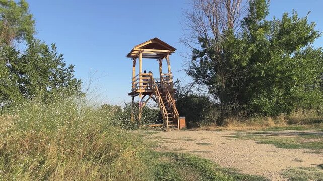 Couple meet lovingly on an observation tower in the park