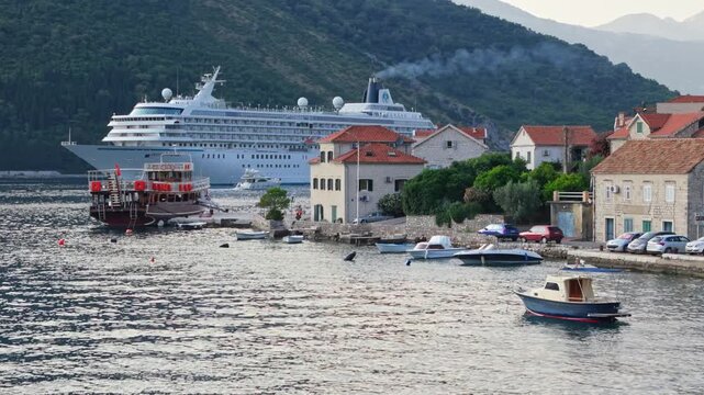 Royal Caribbean cruise ship Voyager of the Seas passing a coastal village in the Bay of Kotor, Montenegro, June 2025