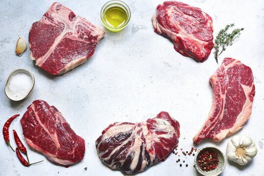 Raw organic marbled beef steaks with ingredients for making.