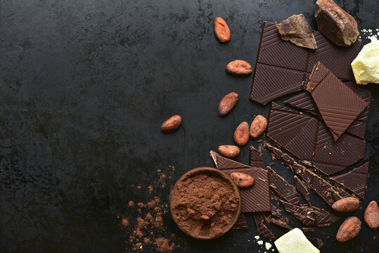 Ingredients for making hot chocolate on a black  background. Top view with copy space.