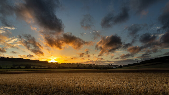 Dramatic HDR sunset clouds over a harvested field in Meon Valley