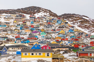 Traditional colorful wooden Inuit houses scattered on the hills of arctic greenlandic town of Qaqortoq, Kujalleq municipality, Greenland. © vadim.nefedov