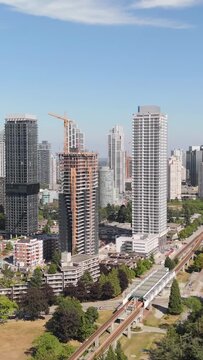 High-Angle View of Modern Burnaby, Vancouver Cityscape with SkyTrain and Tower Construction on a Sunny Day