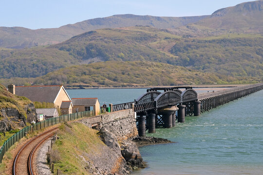 Barmouth Viaduct bridge crossing the Mawddach estuary, with the Cadair Idris mountain range in the background,  Eryri National Park, formally Snowdonia, North Wales, UK.