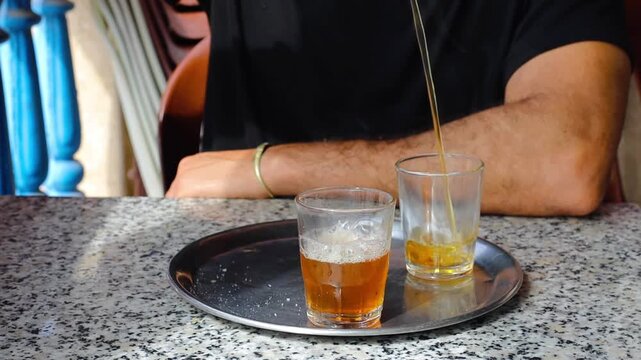 Man face unrecognizable preparing a traditional mint Morrocan tea close up view