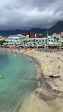 View of Playa La Pinta in Puerto Colon, Tenerife,
Canary Islands, Spain. It is a small beach with volcanic sand, calm waves and transparent water,4K.