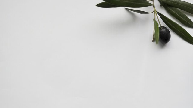 Black_olives_bowl_reveal_on_white_background_copy_space_4k