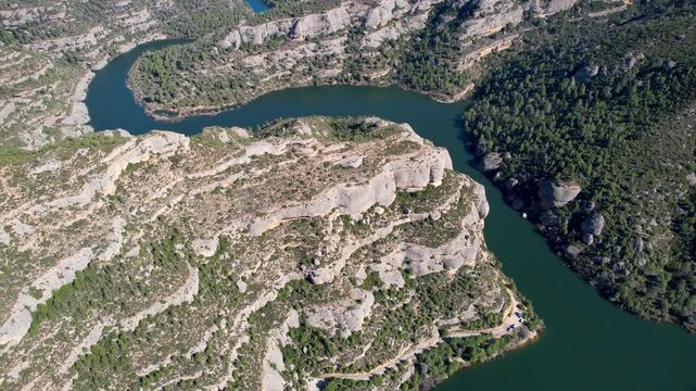 Rising up aerial shot of Margalef reservoir on sunny day. Tarragona Province, Spain.