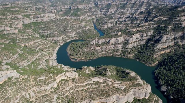 Forward reveal aerial shot of Margalef reservoir on sunny day. Tarragona Province, Spain.