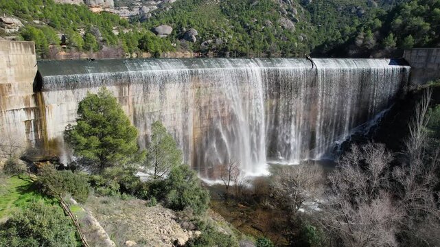 Tripod aerial shot of water flowing through the Margalef dam. Tarragona Province, Spain.