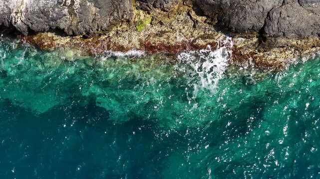 Enchanting moments where Gazipaşa&rsquo;s crystal-clear turquoise waters meet rugged cliffs. An aesthetically pleasing drone shot showcasing the Mediterranean&rsquo;s natural landscape and coastline.