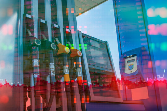 Gas station fuel nozzles with stock market chart overlay representing rising fuel prices and energy market volatility. Economic crisis and petroleum industry concept for inflation and oil trading.