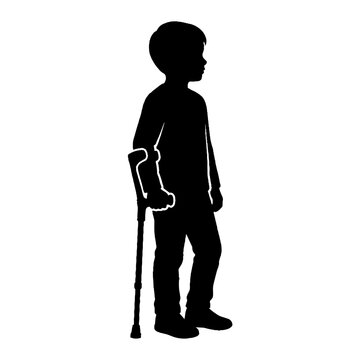 Silhouette of a young boy standing.