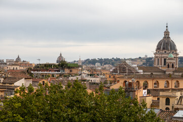 Obraz premium City view on roofs and churches of Rome from panoramic route near villas Borghese and Medici, walking in Rome in spring evening, soft sunset lights, guided tour