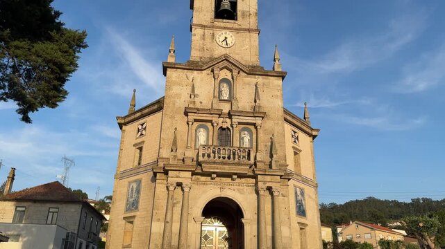 Negrelos, Santo Tirso, Portugal, April 18, 2026: TILT SLOW - The Parish Church of S. Tome de Negrelos.The church is notable for its 16th-century loggia, an architectural feature unique to the region. 