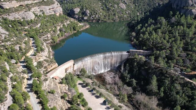 Backward reveal aerial shot of Margalef dam and reservoir. Tarragona Province, Spain.