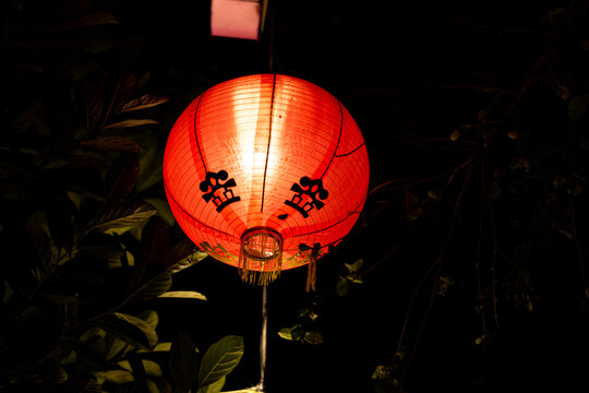 Glowing Red Chinese Lantern Close-Up with Painted Lantern
