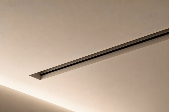 Modern recessed linear lighting fixture integrated into a smooth ceiling surface