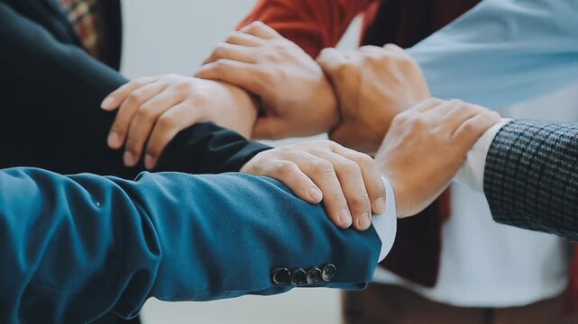 Group of people joining hands together in a teamwork gesture showing unity and collaboration