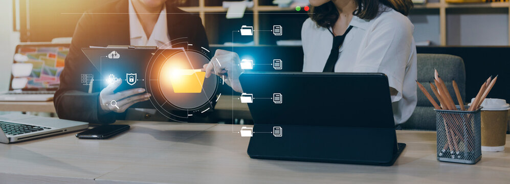 Professional team collaborating using digital folder transfer technology in modern office workspace