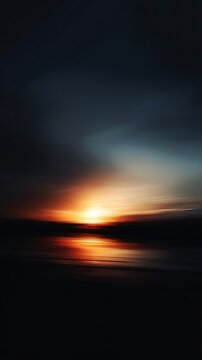 Dramatic vertical sunset with glowing light over a dark reflected surface