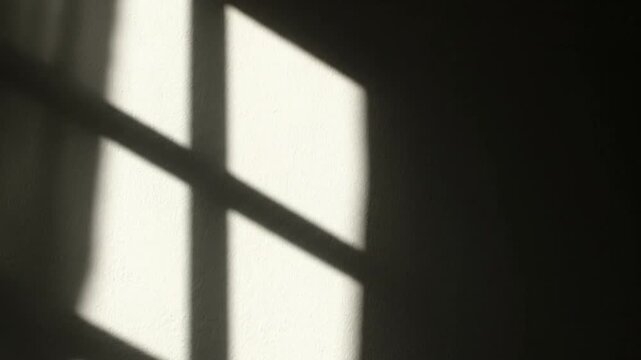 Minimalist Window Frame Shadow on Dark Wall with Dramatic Sunlight Contrast and Cinematic Mood