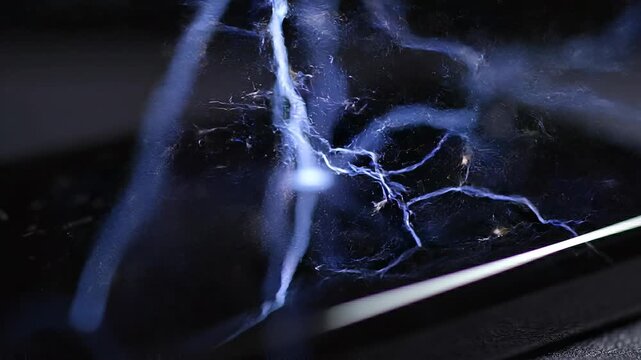 Electricity discharge on a dark surface.