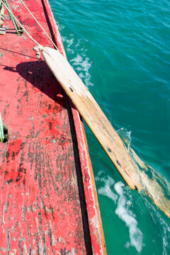 Weathered Red Wooden Jangada Bow with Oar