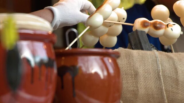 Traditional Japanese Dango Skewers Grilling Over Charcoal at a Tokyo Street Stall