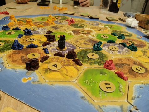 Mozyr, Belarus, April 10 2025: catan board game. Players' chips on the playing field