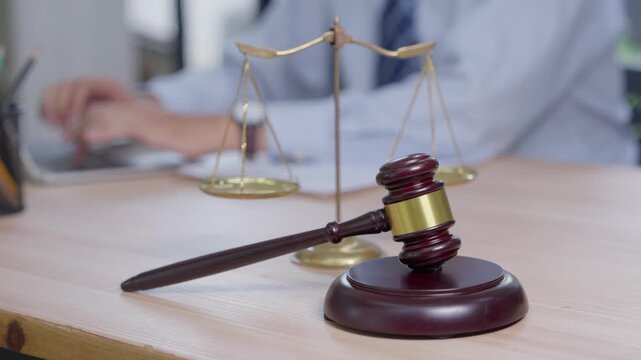 Legal proceedings courtroom gavel and scales indoor office close-up perspective justice system overview