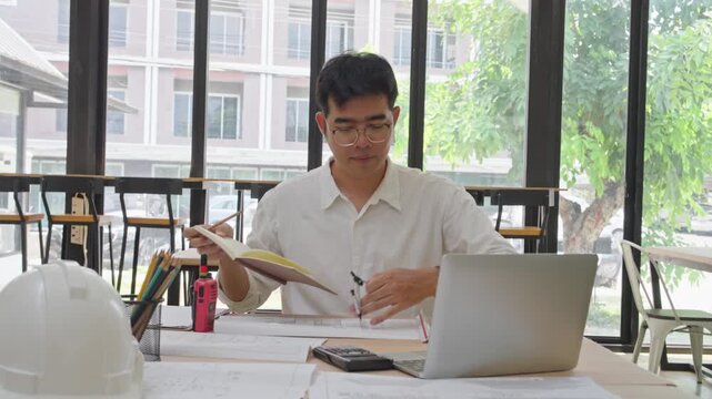 Office work routine young professional analyzing documents in modern workspace indoor environment casual viewpoint