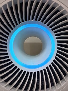 The image shows the top view of a modern air purifier. This device is designed to improve indoor air quality by filtering out pollutants such as fine dust, pollen, and pet dander.