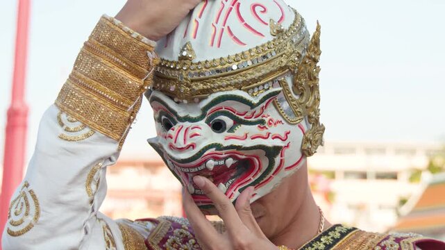 Thai Khon Performer Removing Hanuman Mask After Traditional Dance Performance