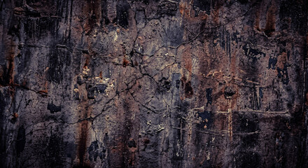 Dark textured background with deeply weathered and heavily cracked old concrete wall showing heavy industrial wear and tear