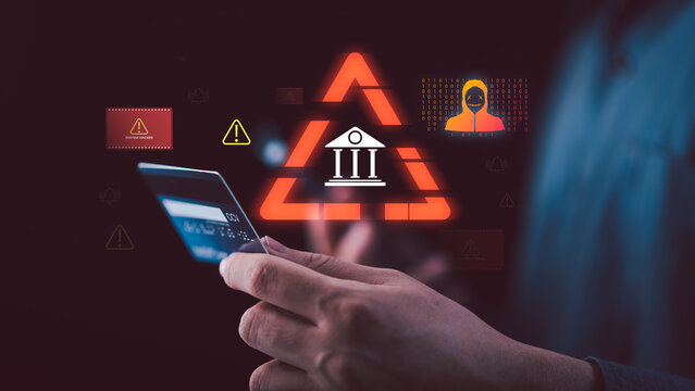 Cybersecurity analyst monitoring digital banking cyberattack and credit card fraud alerts while hackers target online payment systems, exposing financial data breaches and transaction risks.