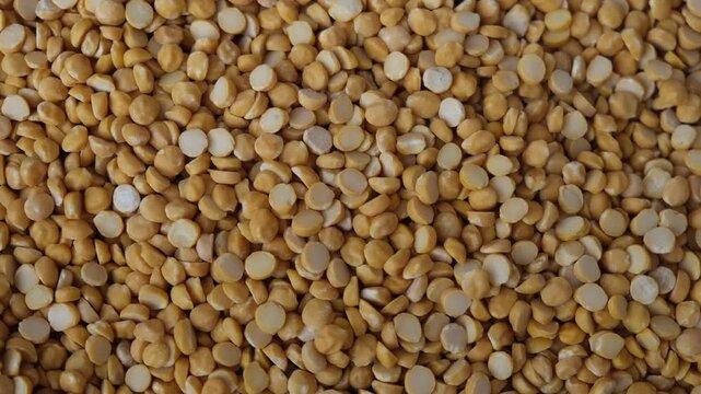 Top view macro shot of yellow split chickpeas or chana dal background