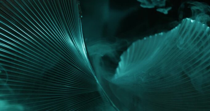 Blue ribbed texture. Fume smoke. Defocused neon color steam curved fog vapor cascade on abstract creative light dark black background.