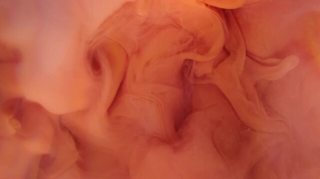 Blur orange mist. Paint fog. Defocused pink color rainbow cloud underwater liquid splash spreading on abstract acrylic background.