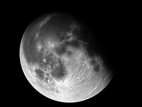The moon's face, a canvas of stark contrasts, where light carves canyons through eons of dust ,  shadow,  geology