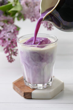 Ube latte in glass. Healthy vegan drink. Viral trendy asian beverage