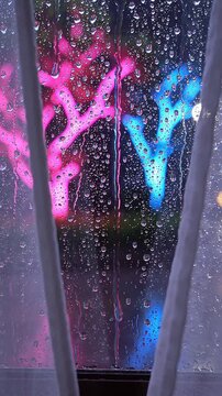 Raindrops on Window with Neon Light Reflections