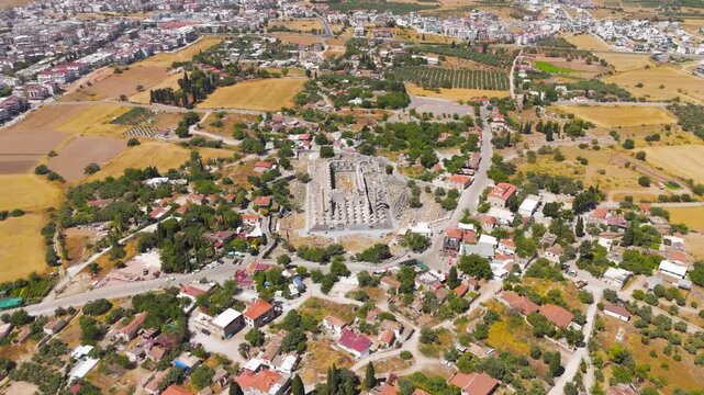 Didim, Turkey. Temple of Apollo at Didyma, towering Ionic columns and stepped podium rising from a rural landscape, aerial drone view under bright summer sun. Aerial View, MasterShots, Circle (Far)